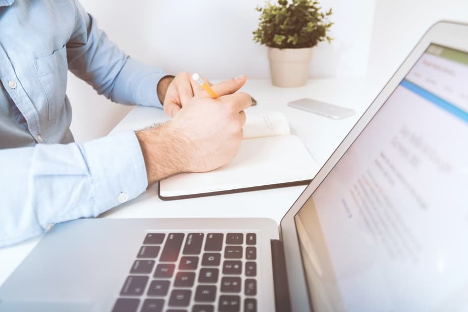 A website designer working in front of a laptop.